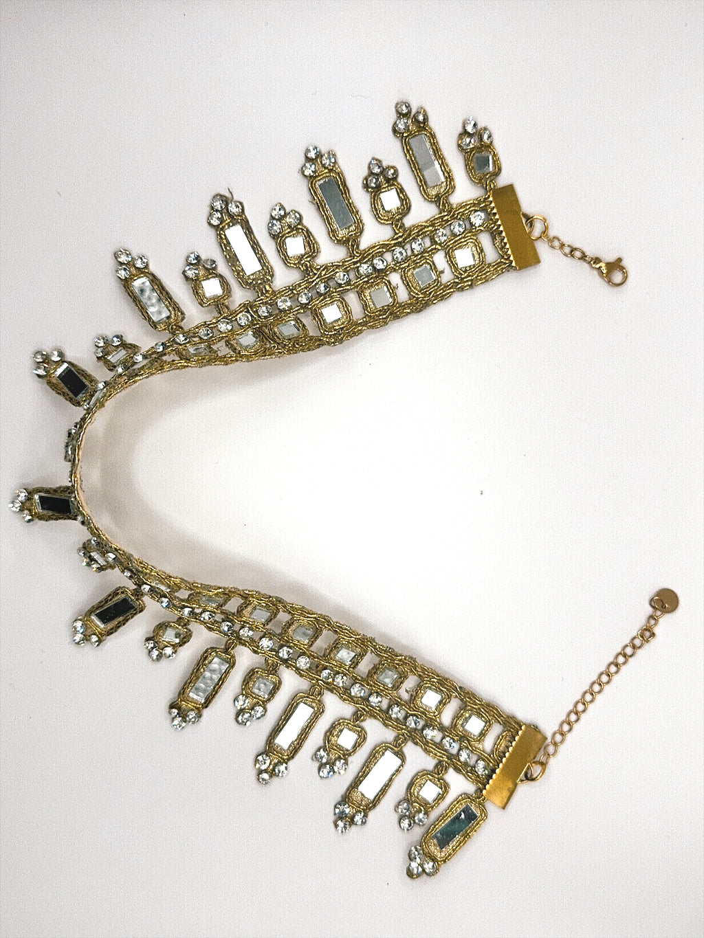 Gold and blue gemstone necklace on a white background