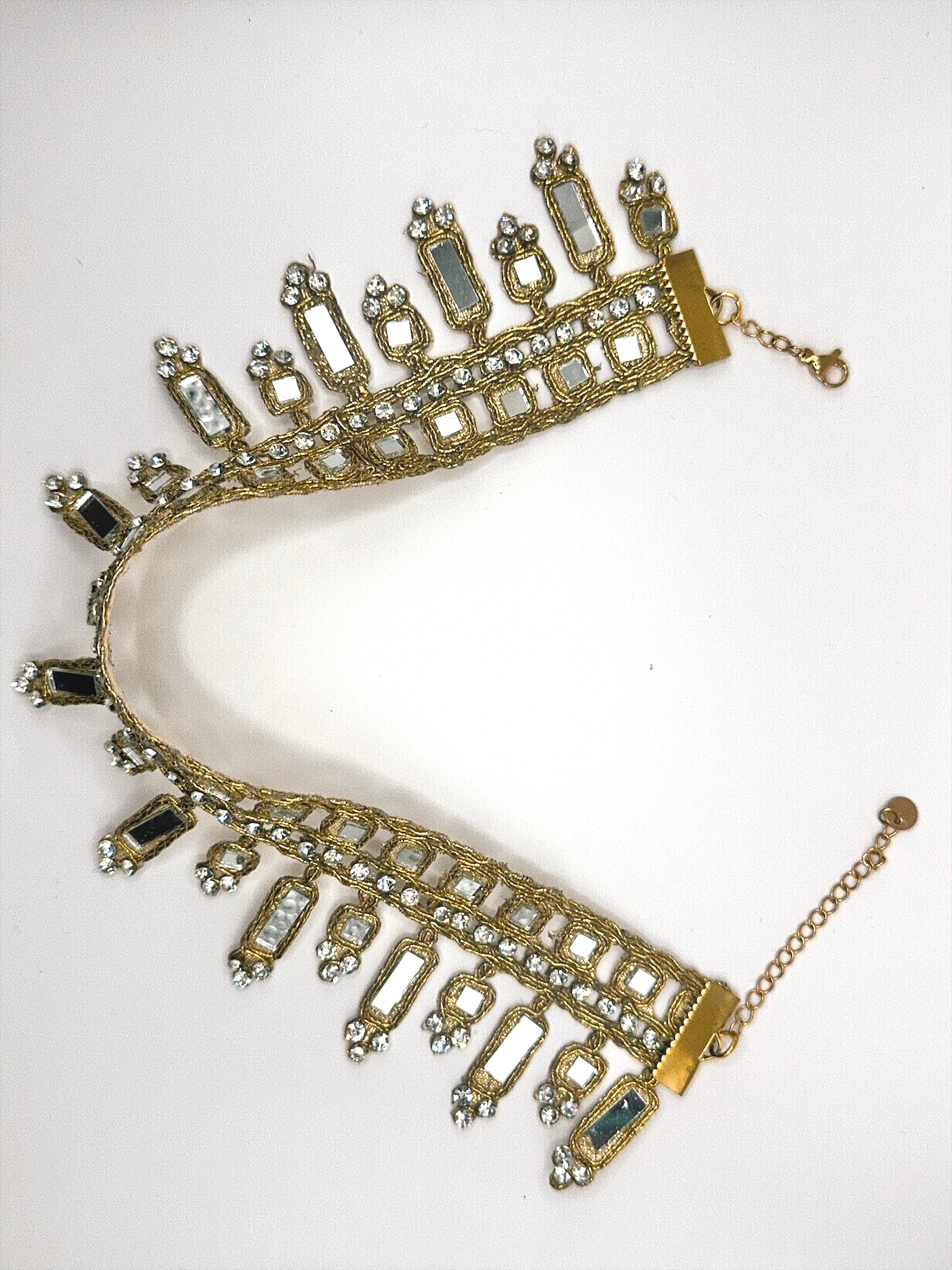 Gold and blue gemstone necklace on a white background