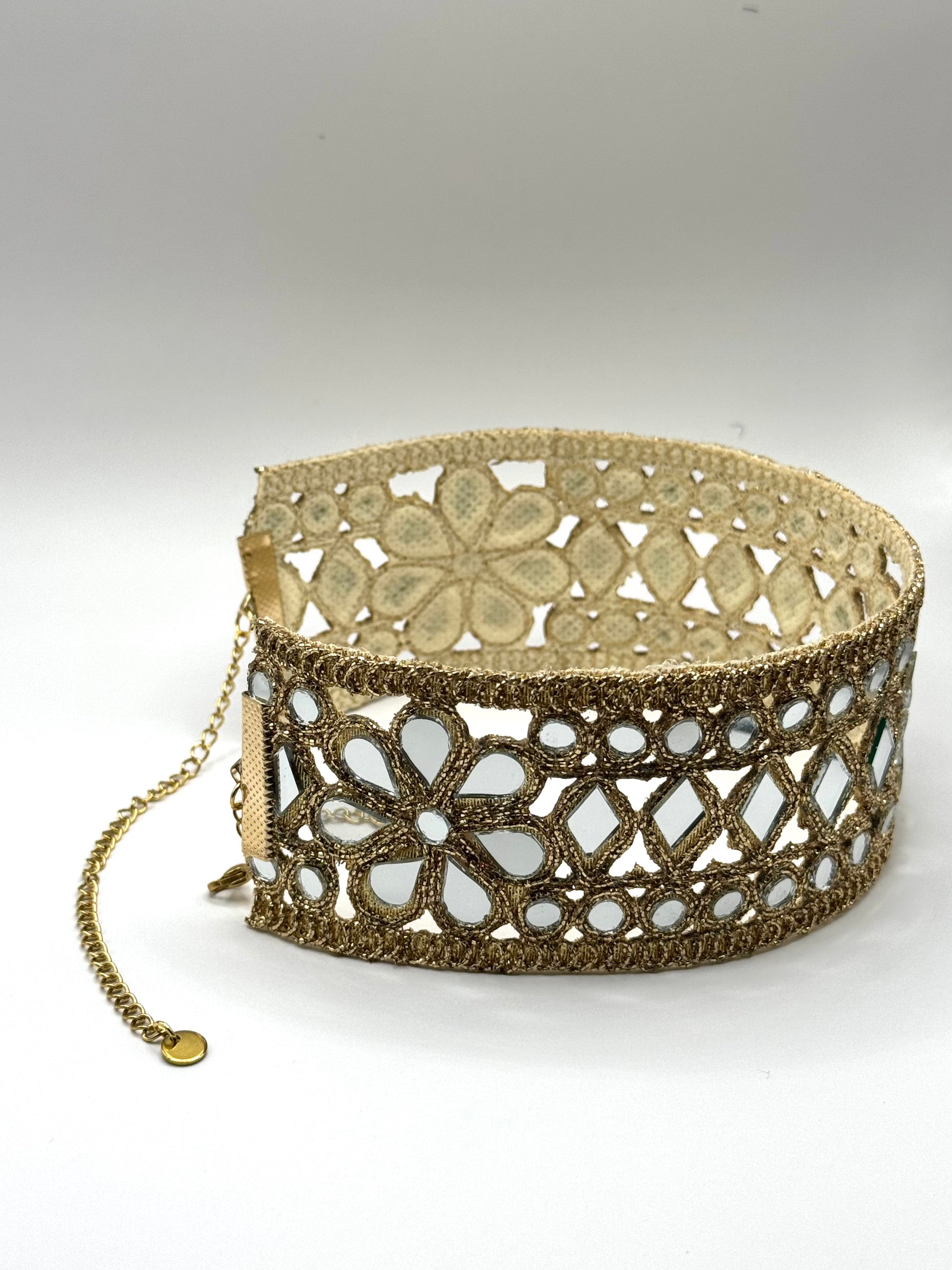 Gold lace bracelet on a white background