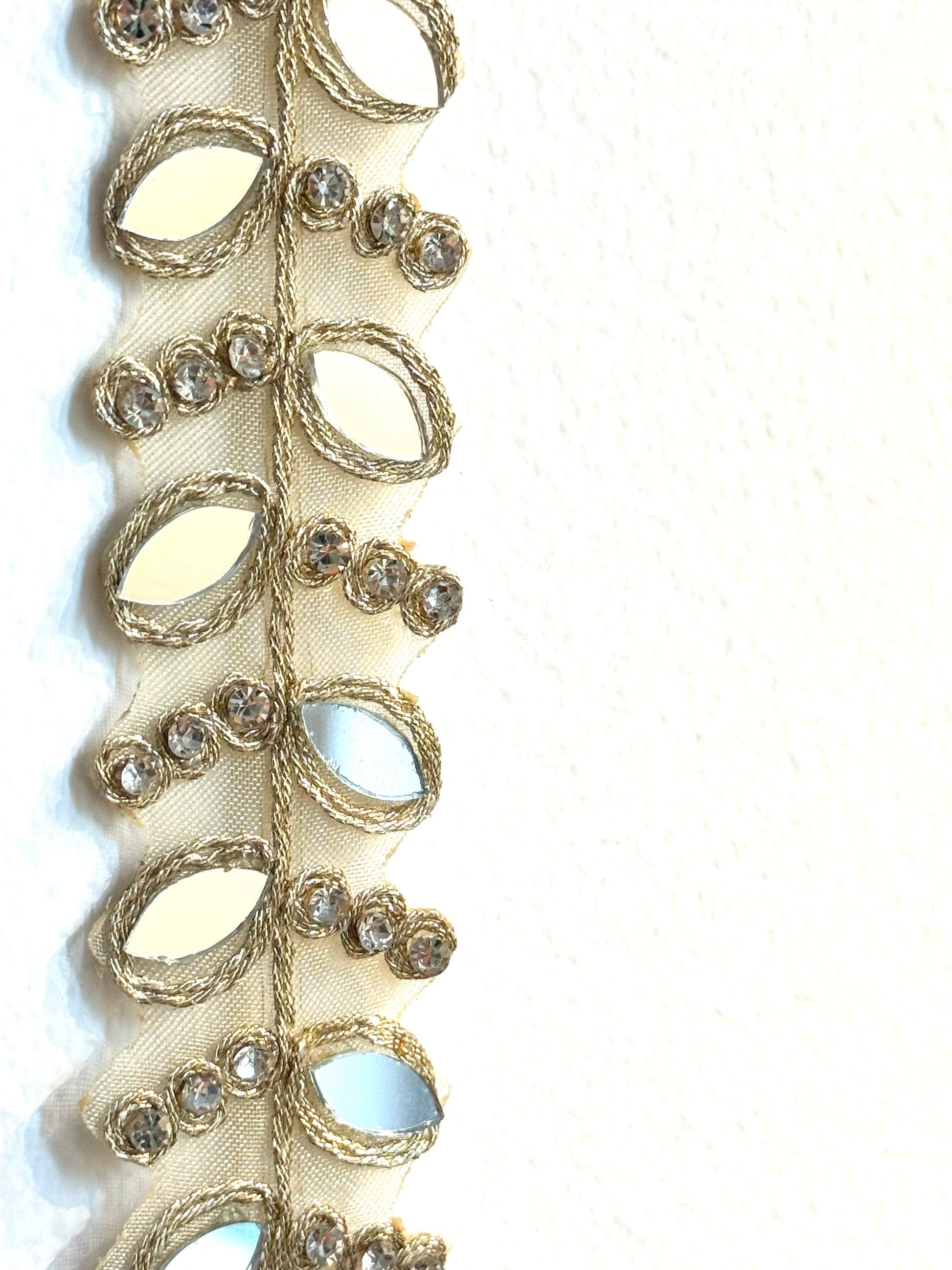Decorative ribbon with gold and silver embellishments on a white background