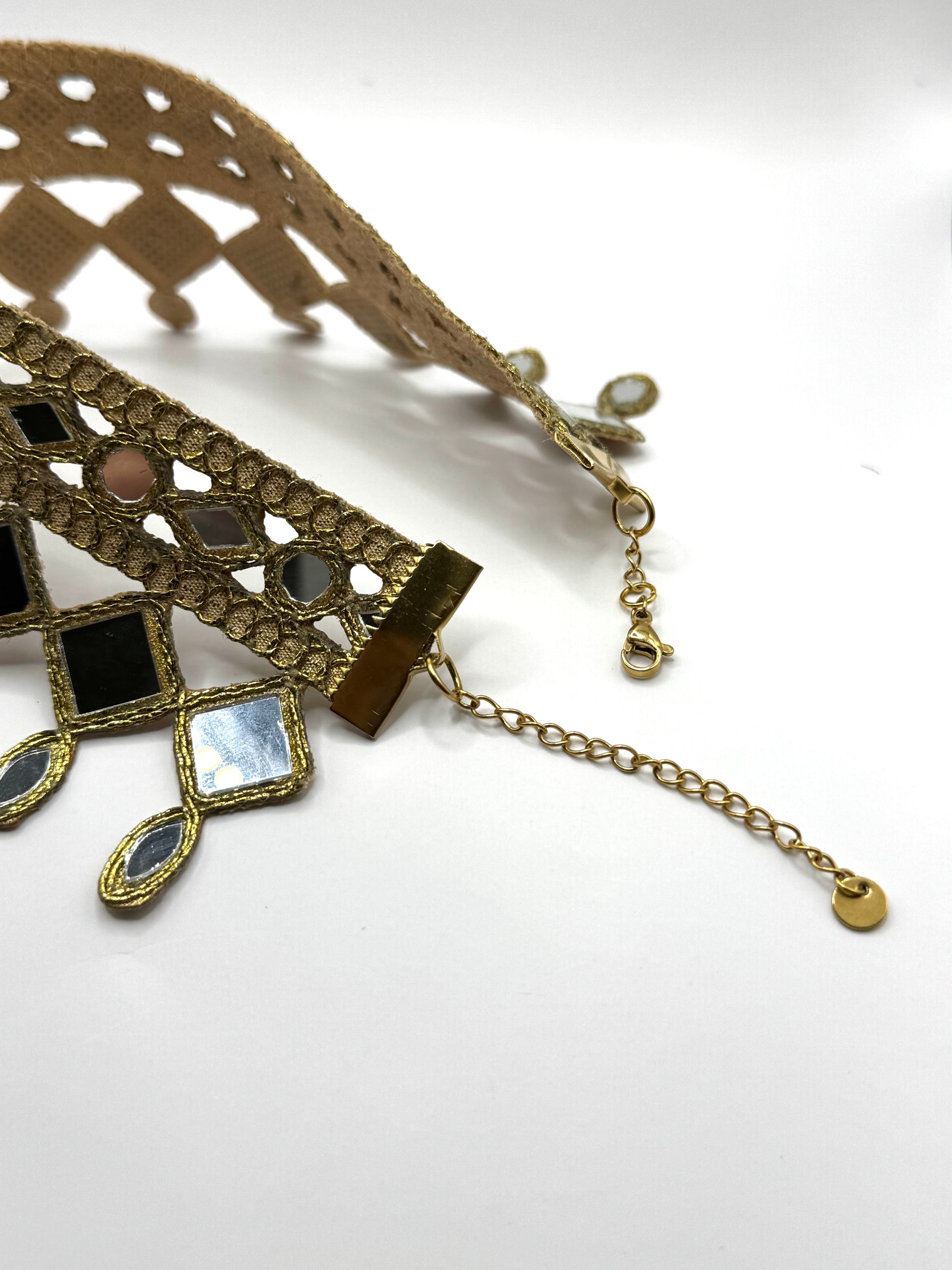 Decorative necklace with intricate design on a white background