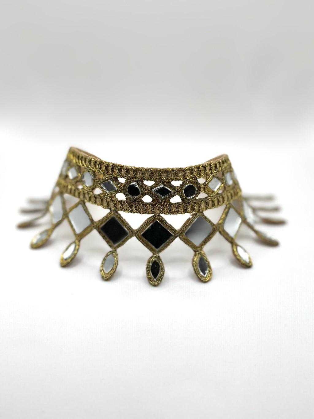 Decorative choker necklace with geometric design on a white background
