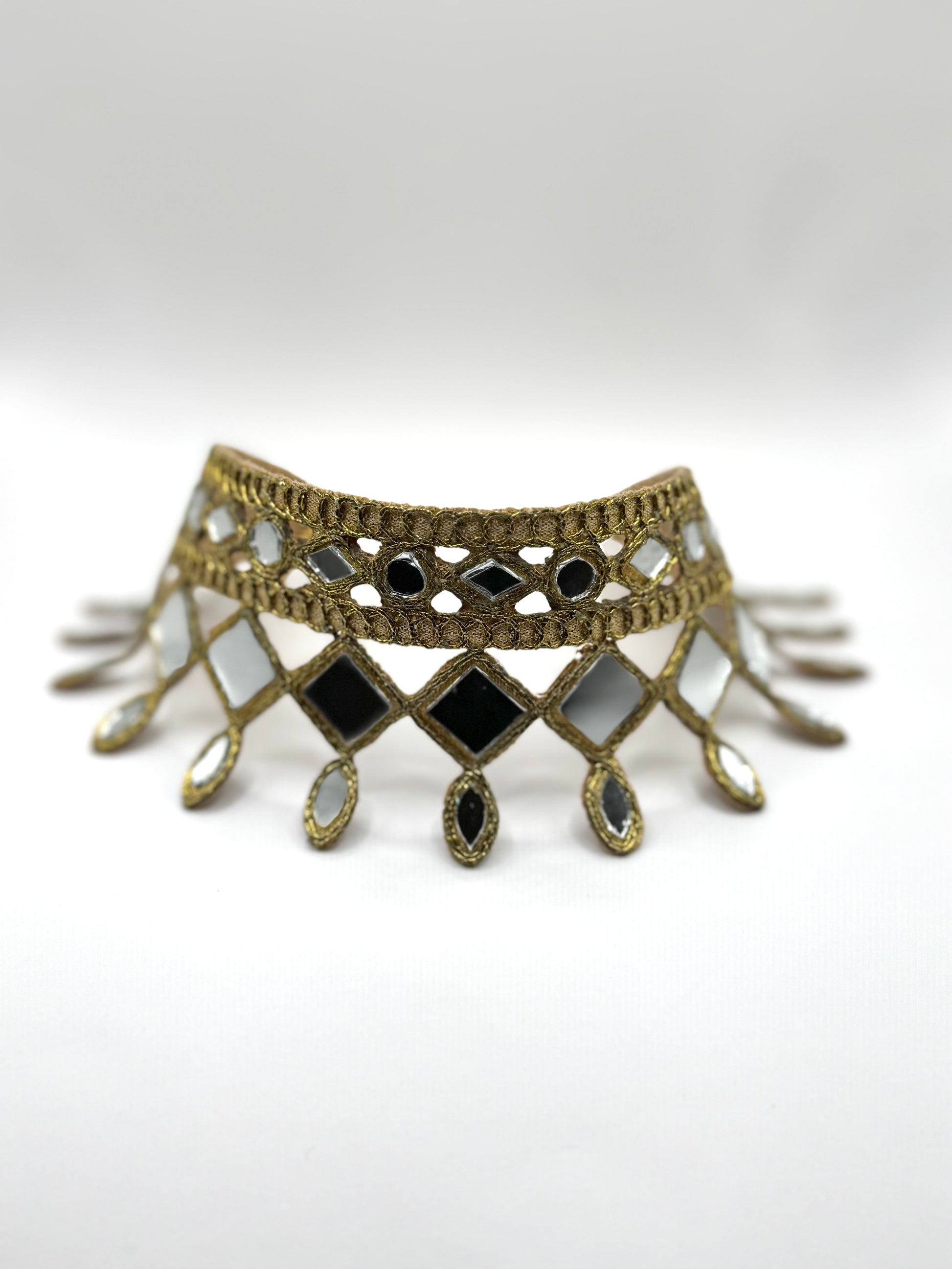 Decorative choker necklace with geometric design on a white background