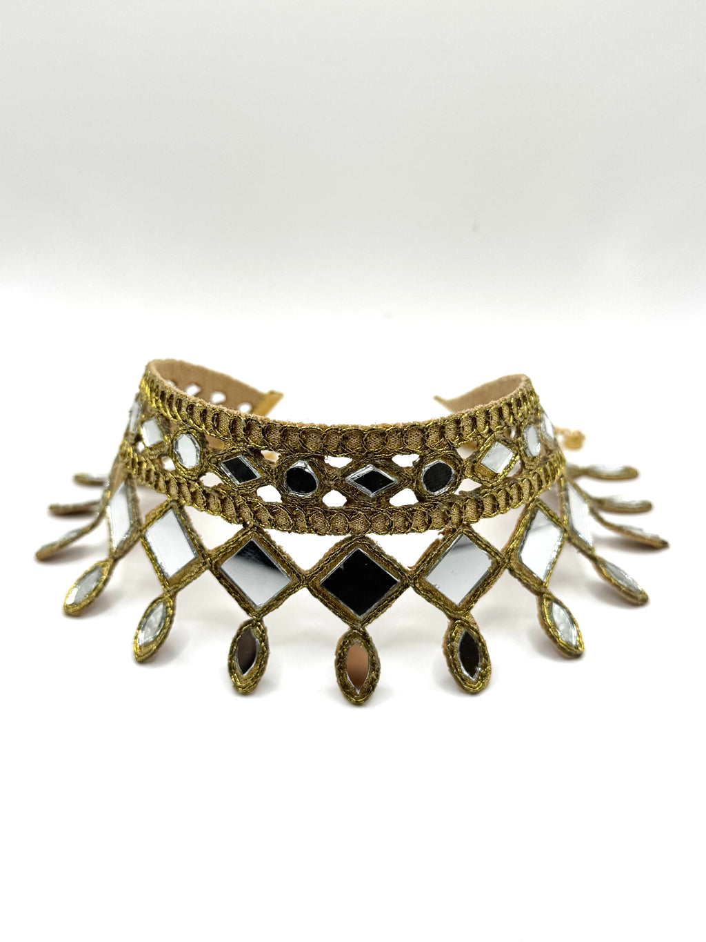 Decorative choker necklace with intricate design and black stones on a white background