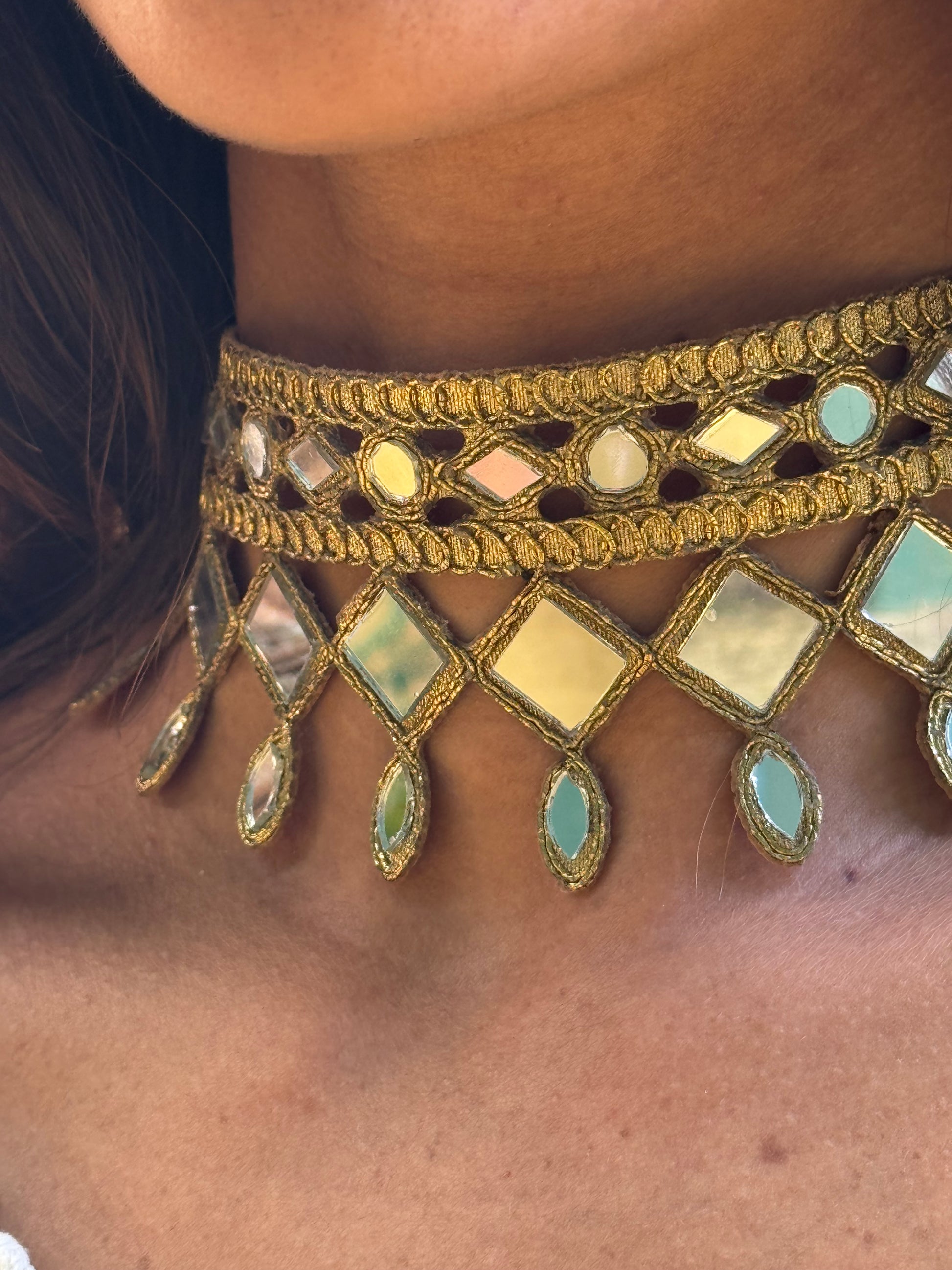 Close-up of a decorative headband with gemstones on a person's head.